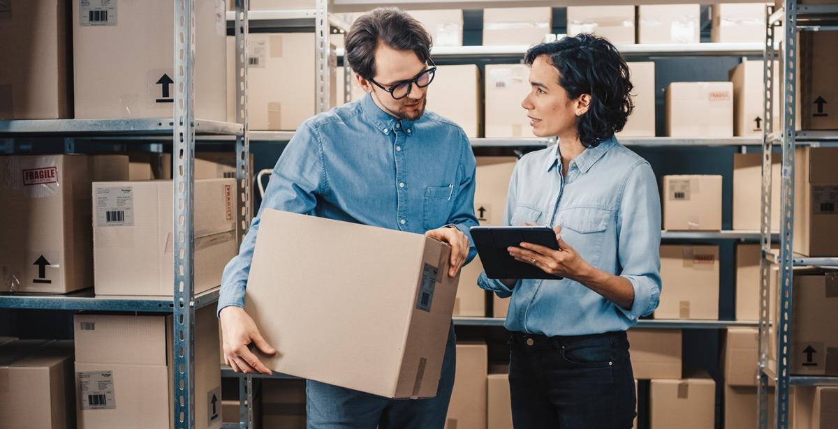 Donna manager istruisce col tablet un magazziniere sul lavoro da fare - Foto di Gorodenkoff da Adobe Stock