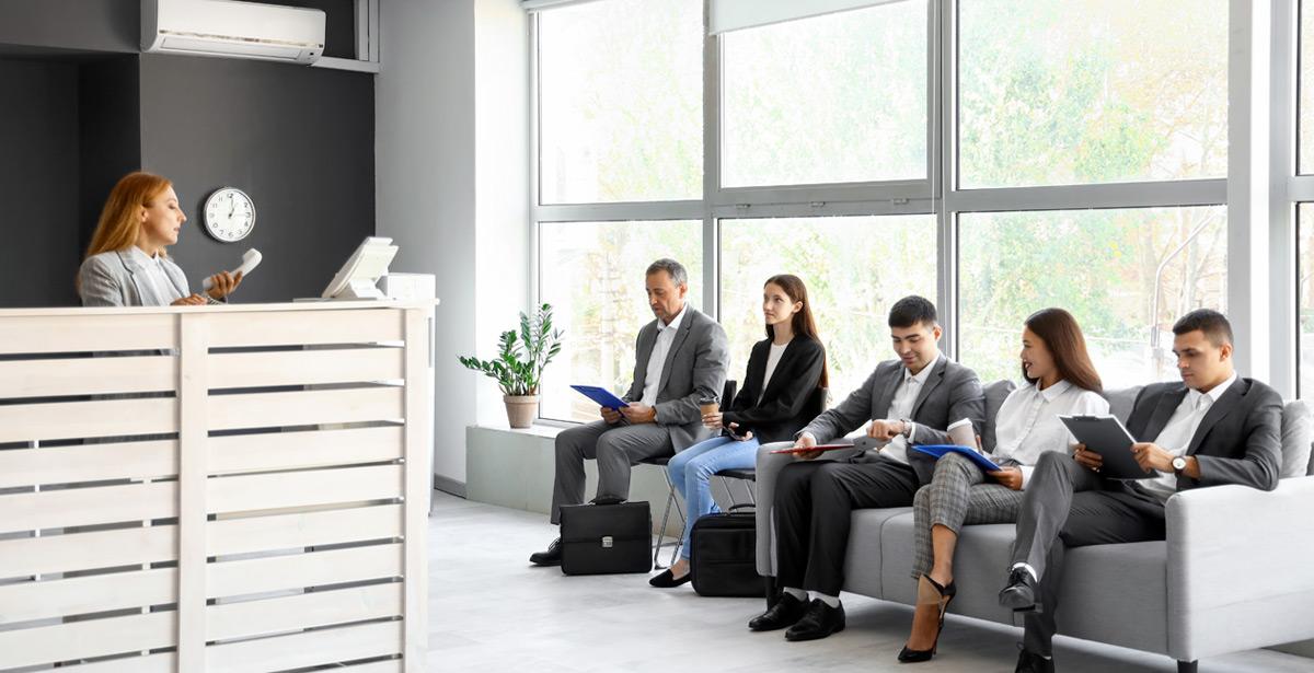 Persone in attesa davanti al desk di un ufficio - Foto di Pixel-Shot da Adobe Stock